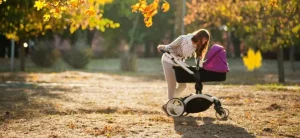 Efluvio telógeno y embarazo 1 Madre paseando a su bebé en un parque en Otoño